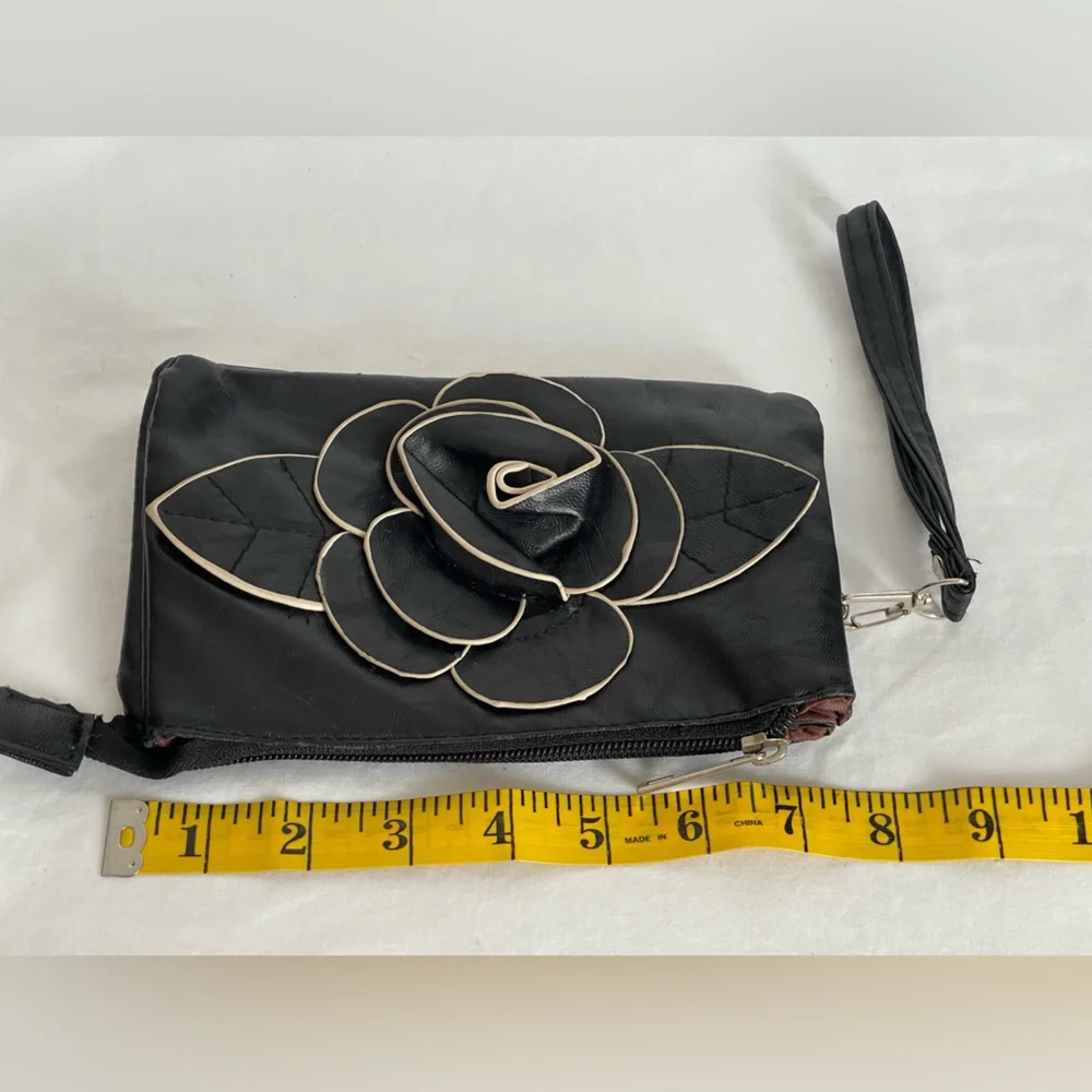 Fun little black faux, leather clutch wristlet three pocket with a zipper